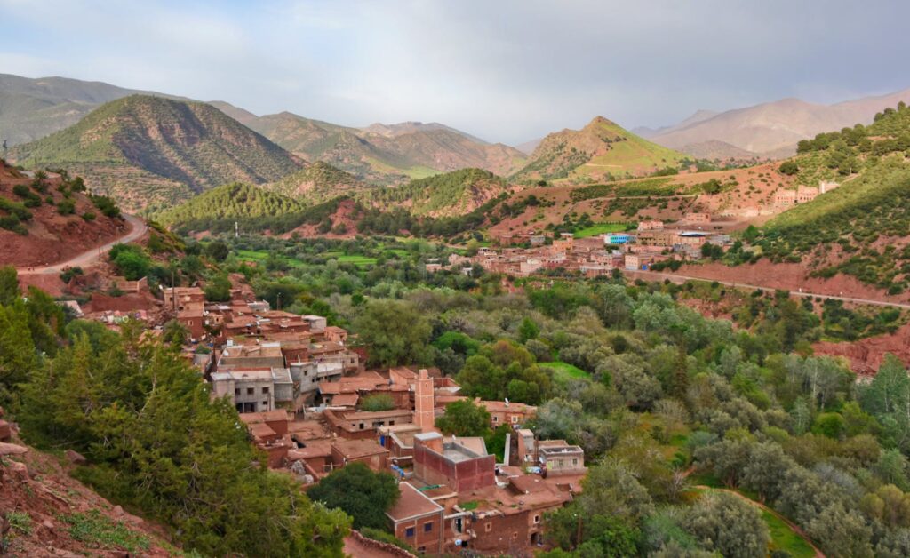 Scenic aerial view of Ait Barka village amidst lush green valleys and rugged mountains.morocco travel morocco 9 days tour from casablanca